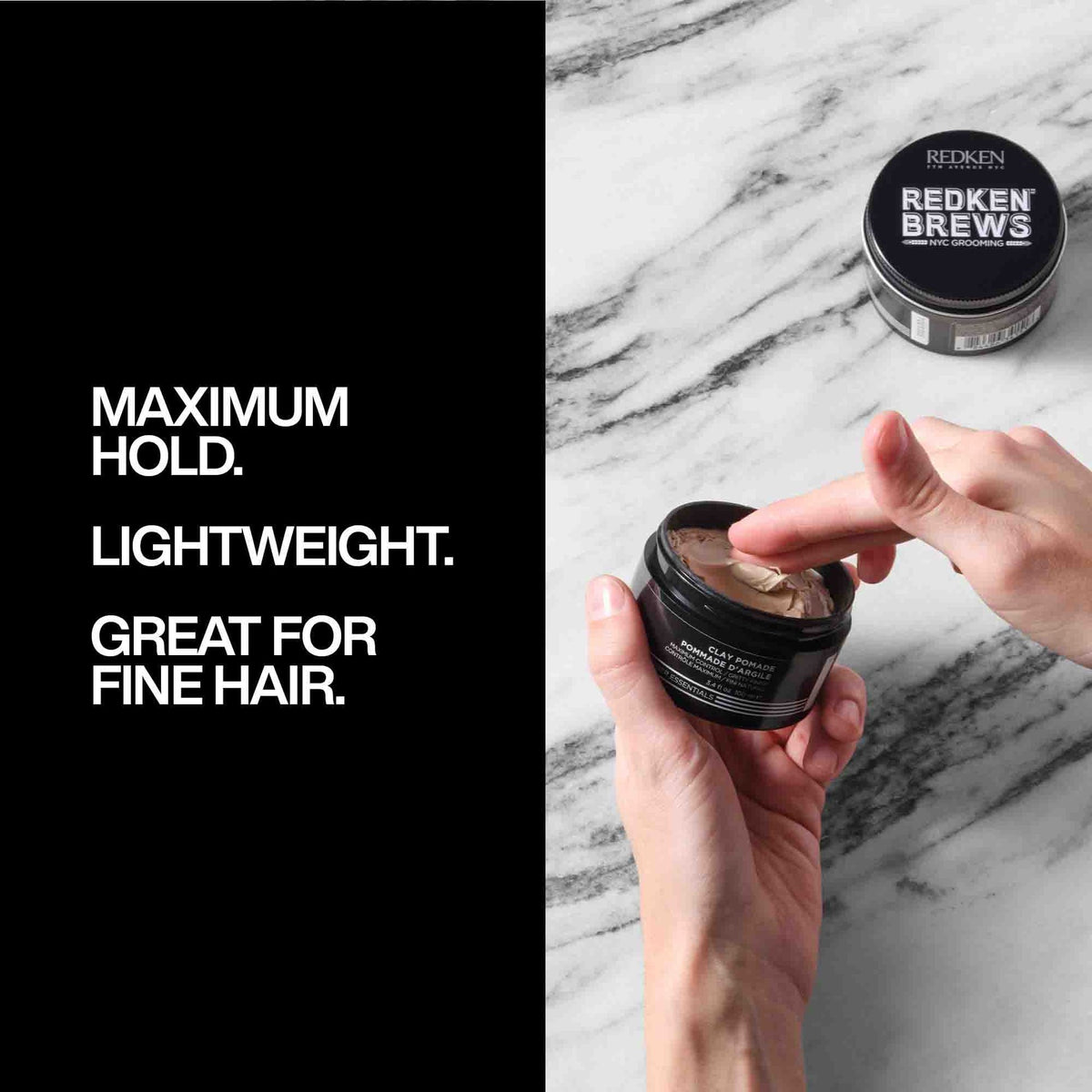A hand holding an open jar of Redken Brews Clay Pomade