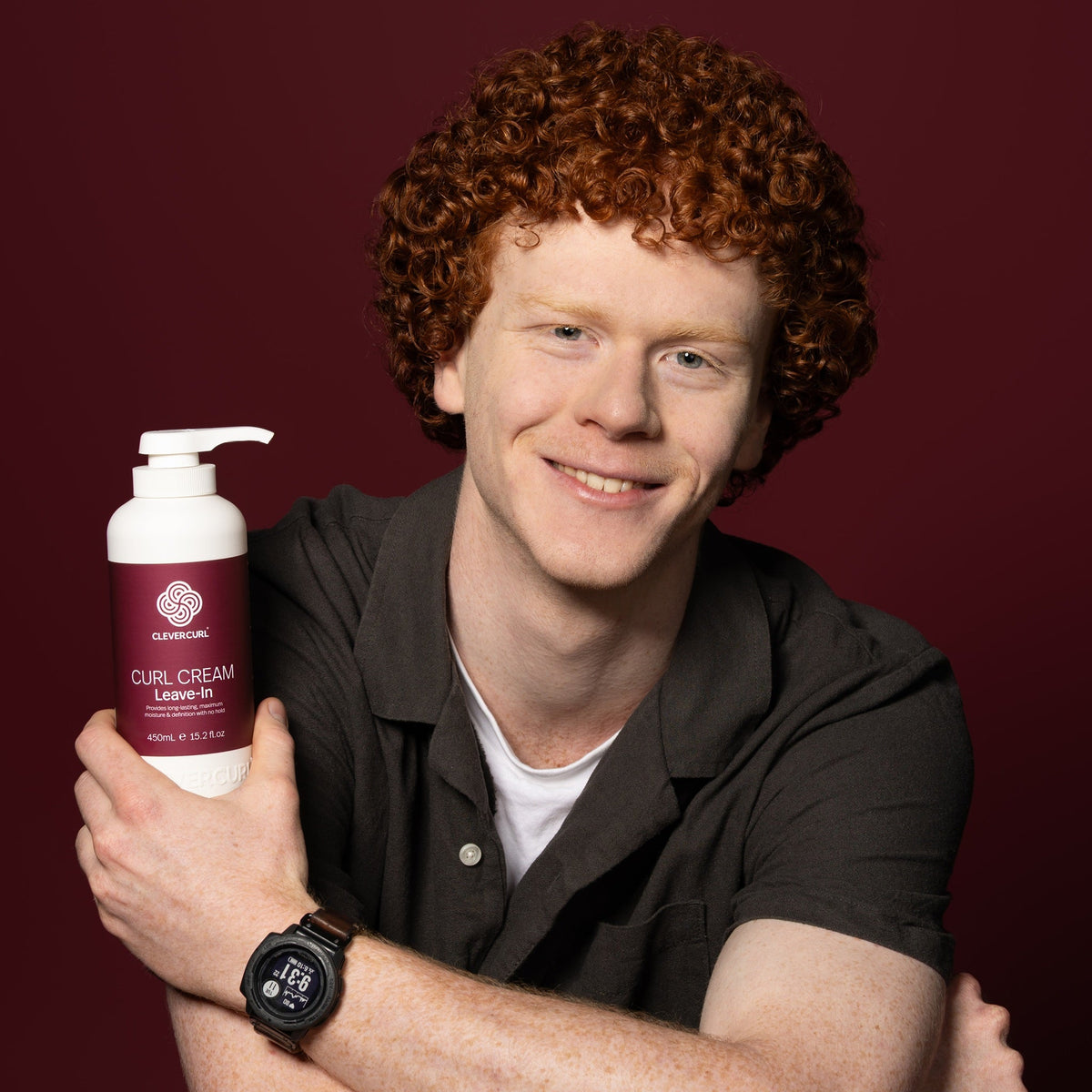 Man with red curly hair holding Clever Curl Curl Cream Leave-In 450ml