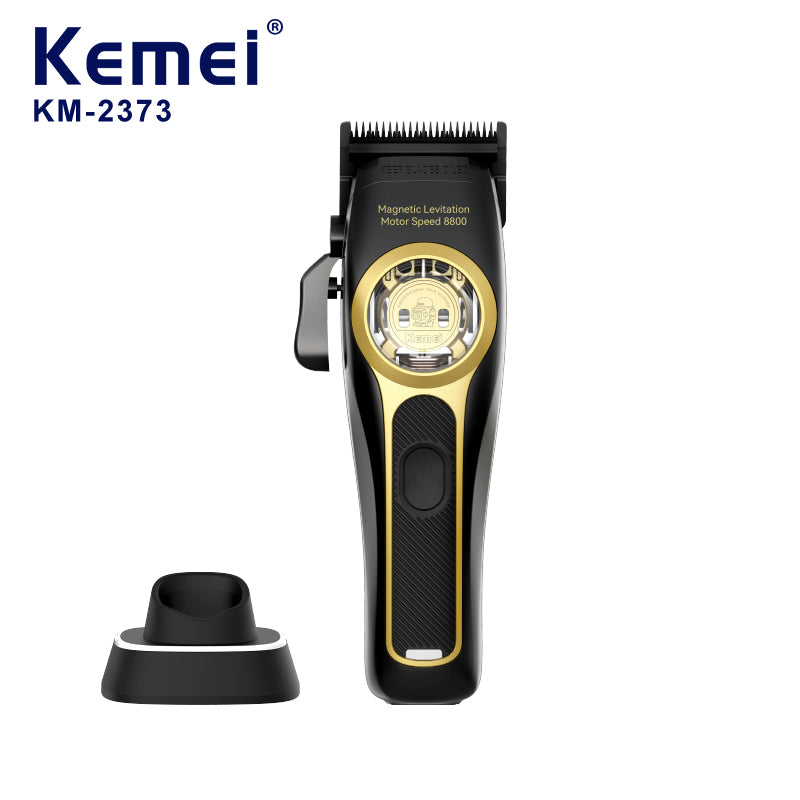 Kemei KM-2373 cordless hair clipper in black and gold beside its charging base