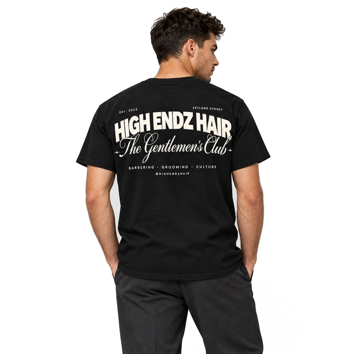 Man wearing the black High Endz Hair Gentlemen's Club Tee, back view