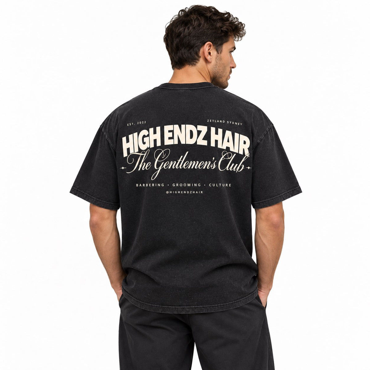 Man wearing the stone wash High Endz Hair Gentlemen's Club Tee, back view